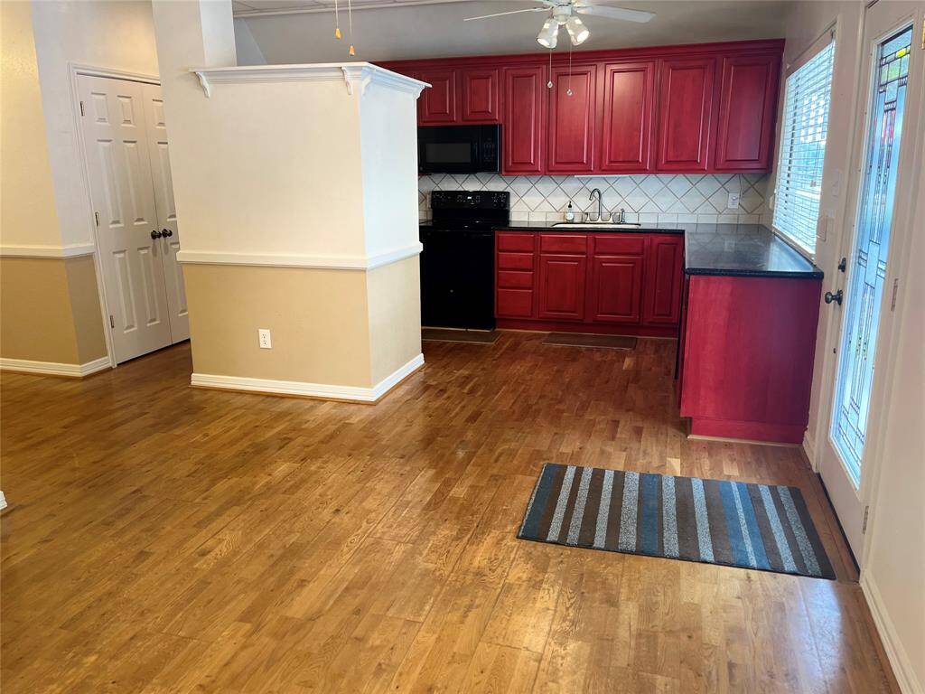 The living room to kitchen.  Great for entrtaining guests. Open, laminate flooring.