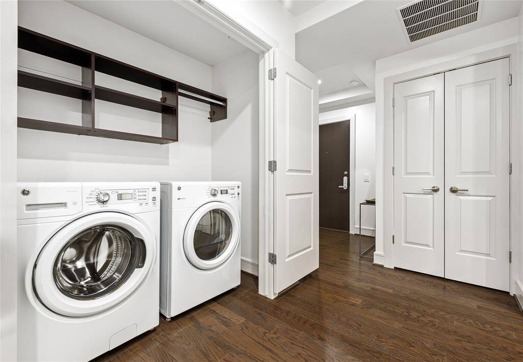 laundry in entry way with custom storage shelves