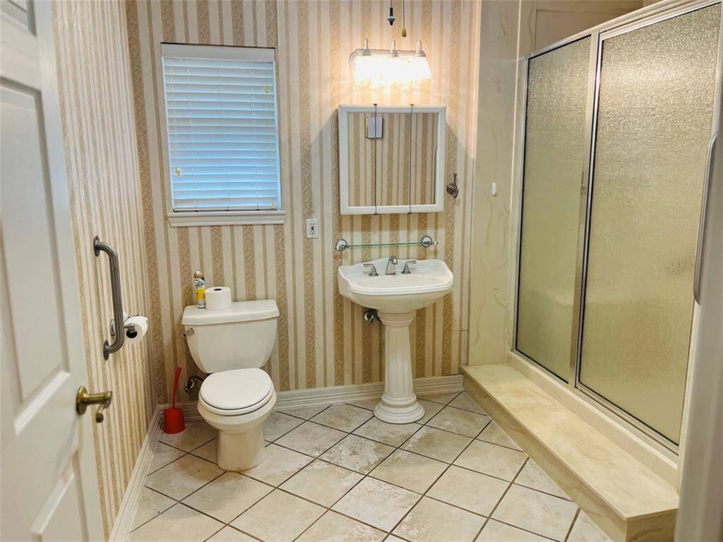View of full secondary bath just off guest bedroom.  Gorgeous pedestal sink.