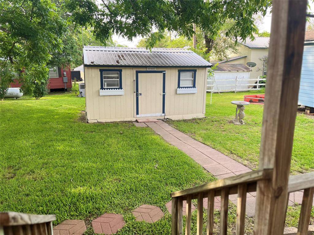 View from the secondary living qauarters to the backyard space. Stepping stone walkway.  Large pecan tree not only offers shade but producing plenty of crumptous pecans.