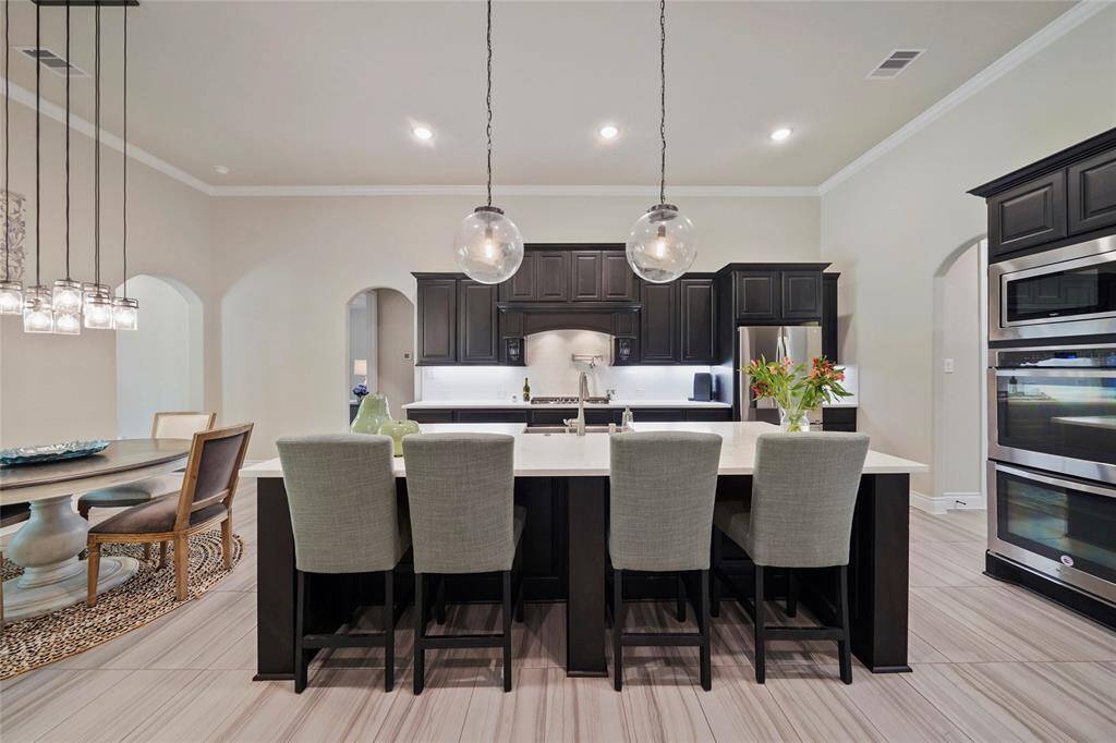 This kitchen includes double ovens, gas cooktop, pot filler and beautiful quartz countertops.