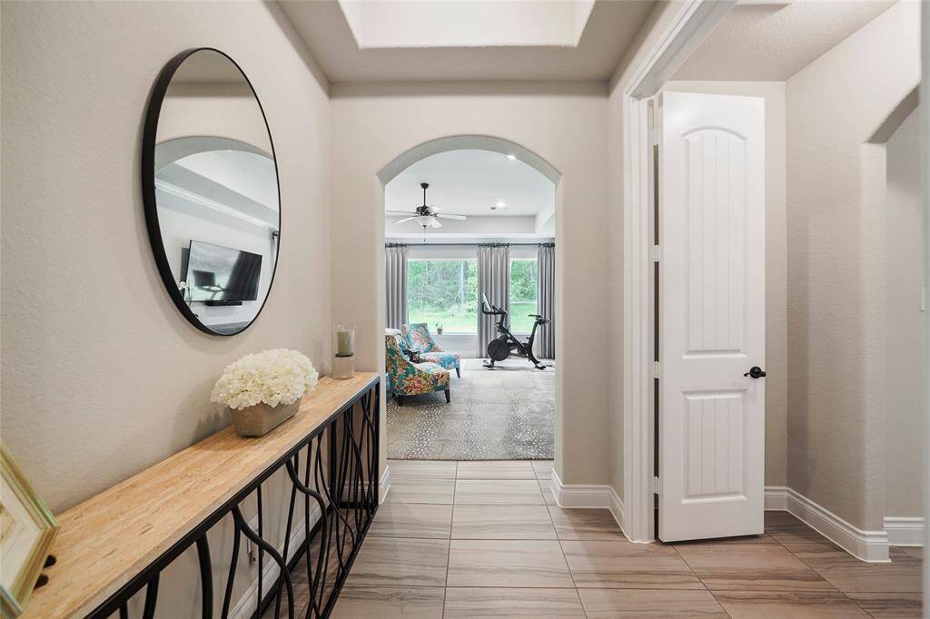 The vestibule opens through the arched doorway to the private primary suite.