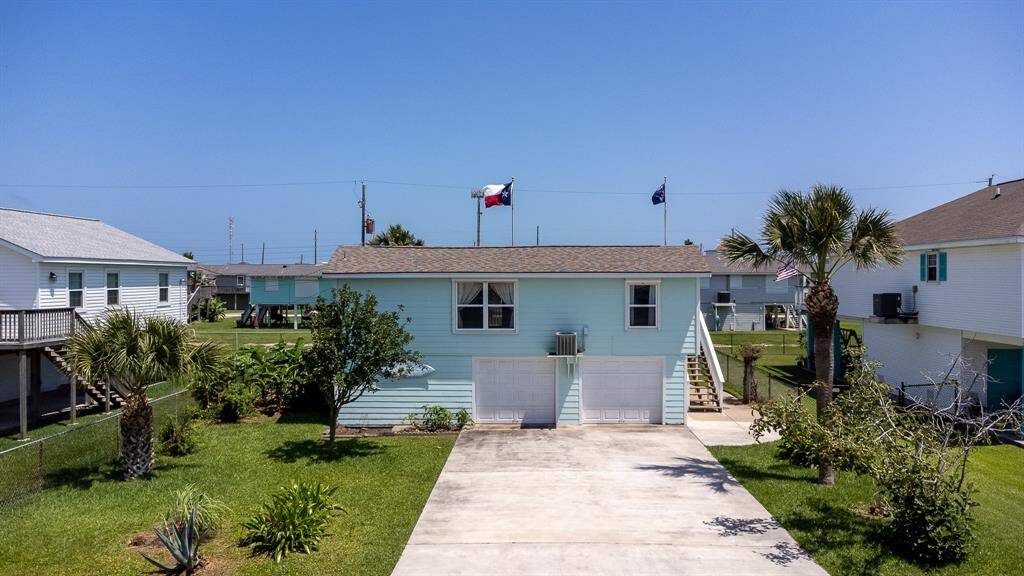 Expansive double driveway with dual garage and extra enclosed storage space.