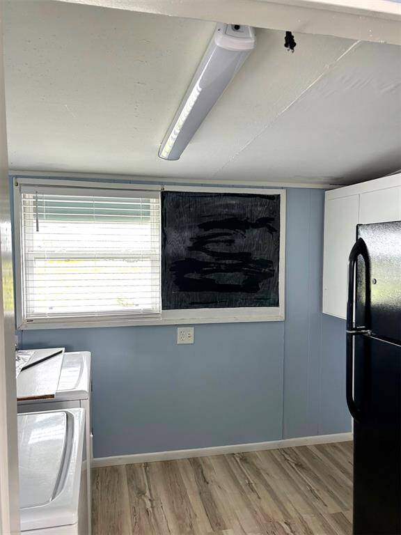 Utility Room off kitchen with fridge plus full washer and dryer - all kitchen and utility room appliances will convey with the property