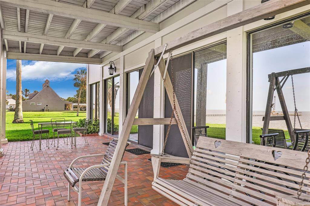 Covered patio off living area and facing the bay with a nice breeze