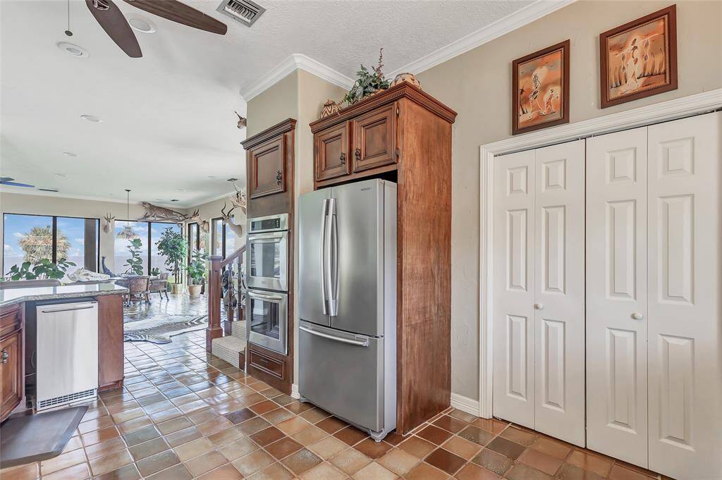 Spacious open floor plan with views of bay throughout the kitchen and living area
