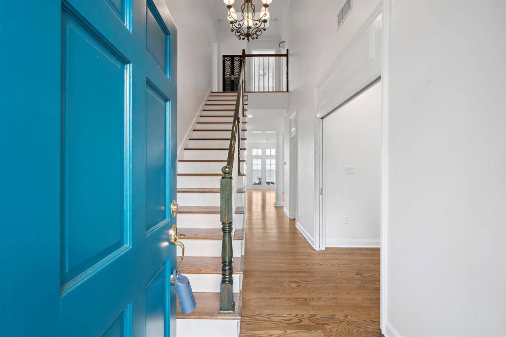 Two story foyer and hallway leading to the living room