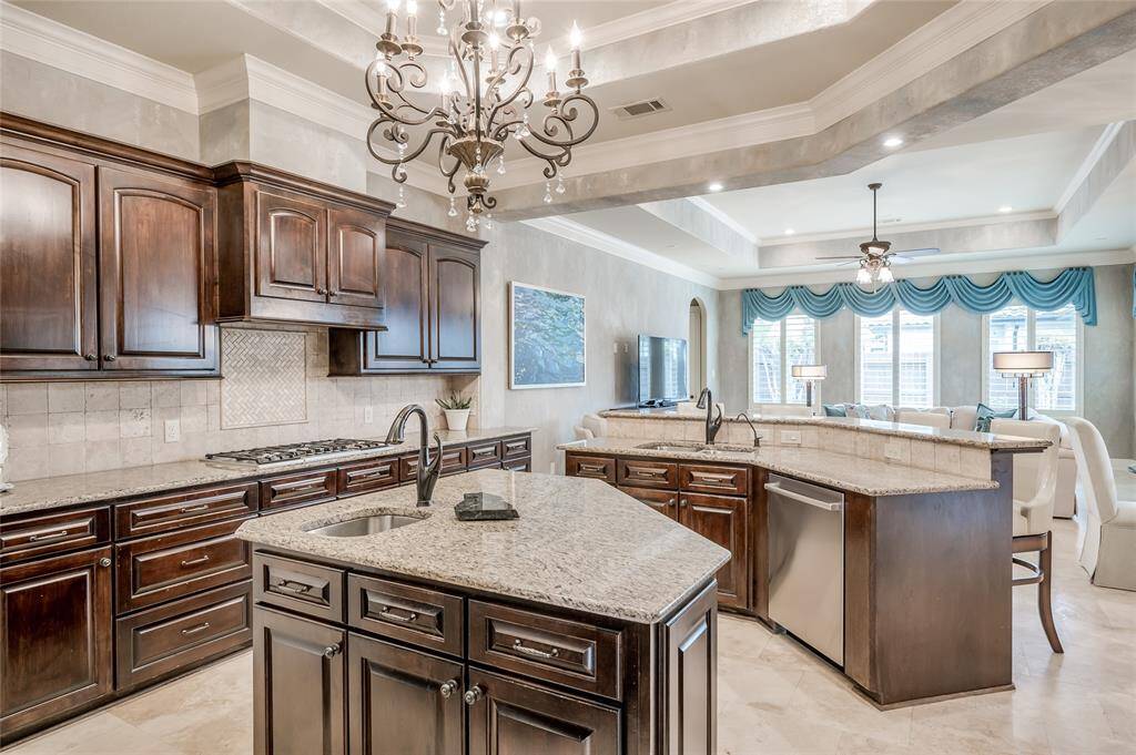 The kitchen opens to the family room with a breakfast bar that acts as a transition point between the two spaces, providing additional seating.