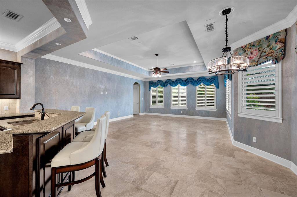 Soft Venetian finish walls accentuate the beauty of the custom details in the home. Located through the arched doorway you will find a generously sized bedroom and a full bath.
