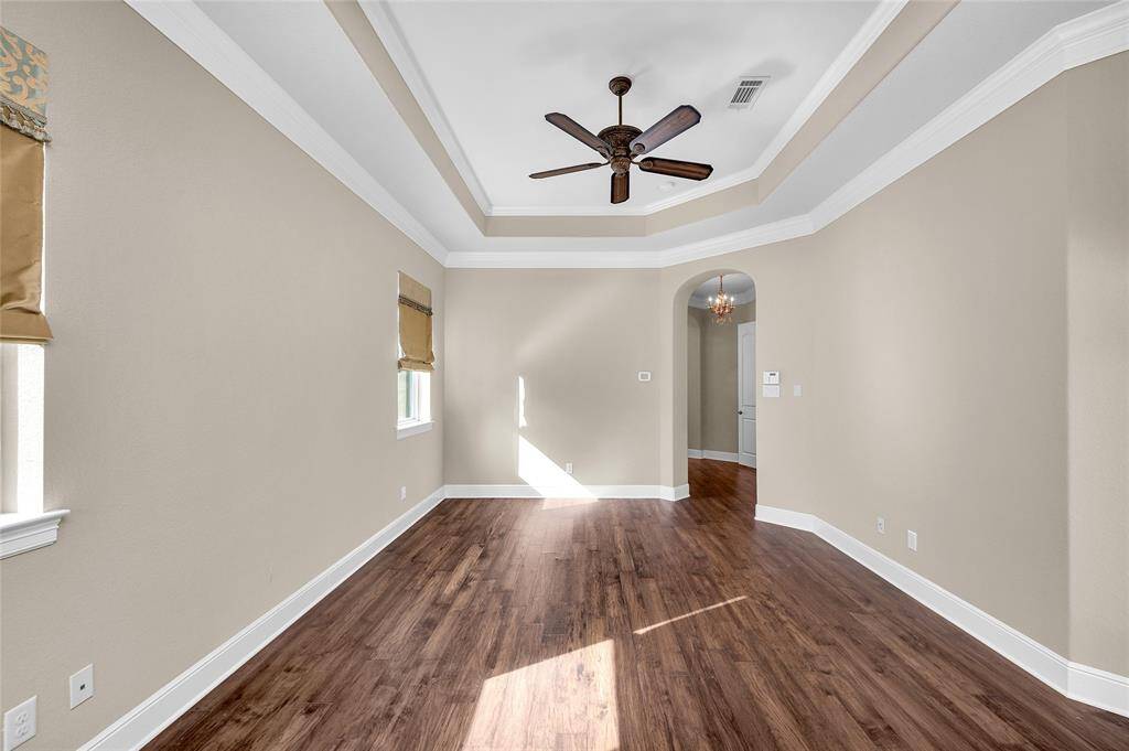 Rich wood flooring compliments the architectural details and understated elegance of the owner's suite. A private vestibule entry leads to the tranquil spa bath and walk-in closet.