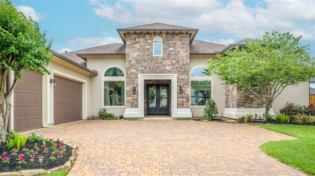 Grand double iron doors highlight the beauty of the Tuscan design