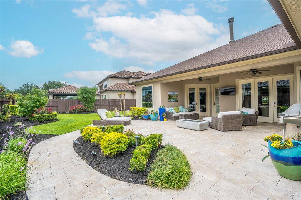Outdoor living space you will truly want to live in. Lanai with extended living area and natural travertine stone.