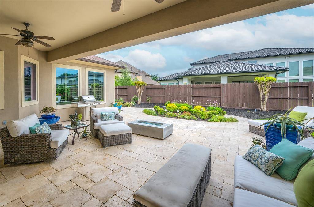 Natural travertine stone seamlessly flows to the outside lanai and stays cool underfoot. Relax under the breeze of dual fans.