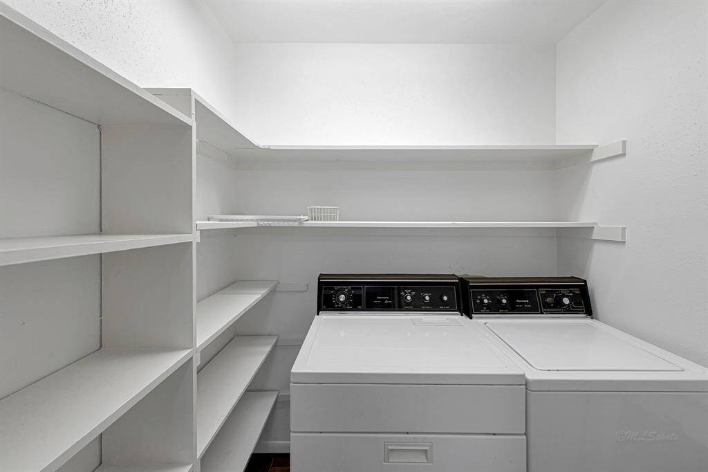 Laundry room with additional shelving for storage