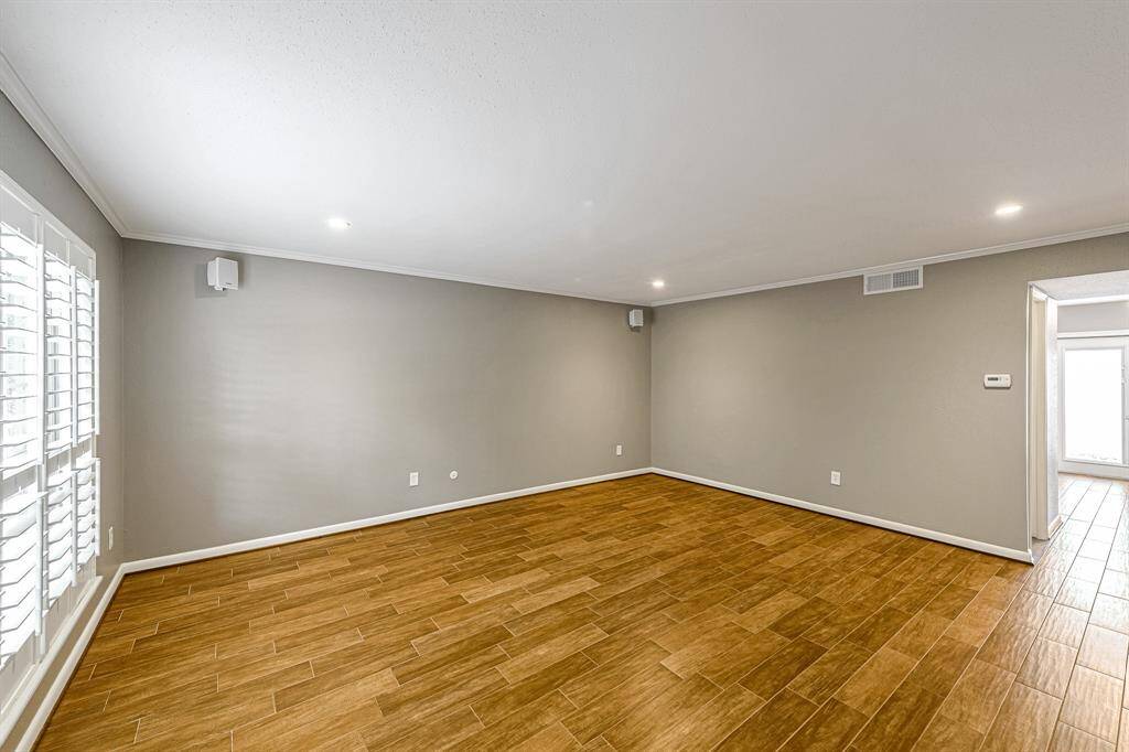 Large Living room with recessed lighting and wood laminate floors