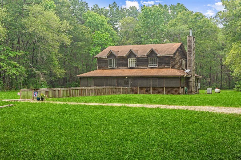 Home situated in clearing in the center of property.