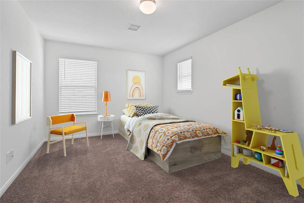 Secondary bedroom features plush carpet, custom paint and a large window.