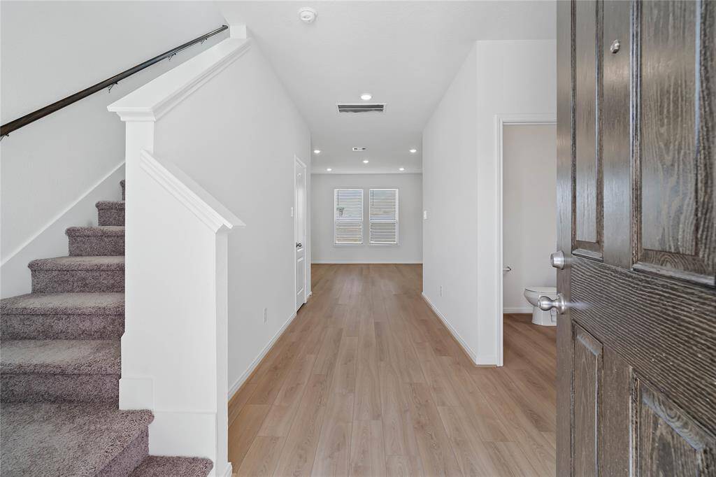Welcome to your new home at 21214 Montego Bay Drive. You are greeted with this beautiful entryway featuring vinyl plank flooring and custom paint.