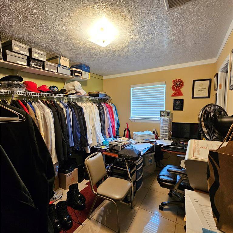 Unit B_Bedroom 3 (used as a walk-in closet and office space)