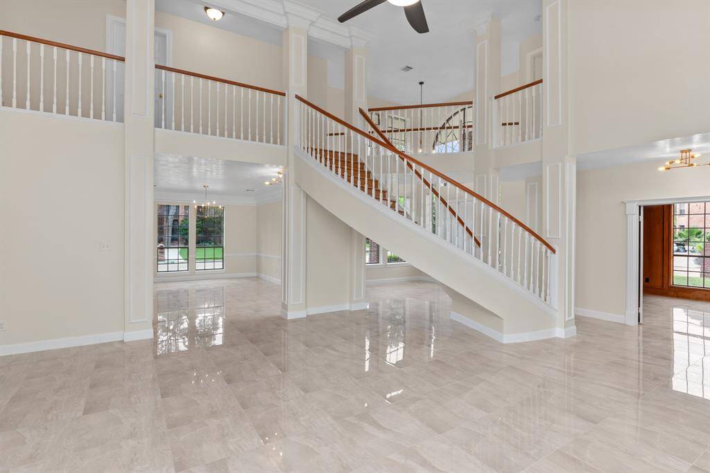 View from the 1st expansive Living room towards office, staircase, entrance and Dining Room