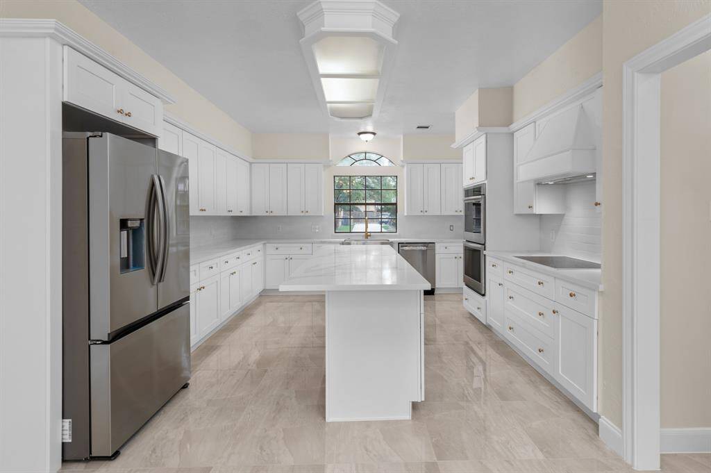 Kitchen, featuring quartz countertops, top-of-the-line appliances, and a massive island (1st floor)