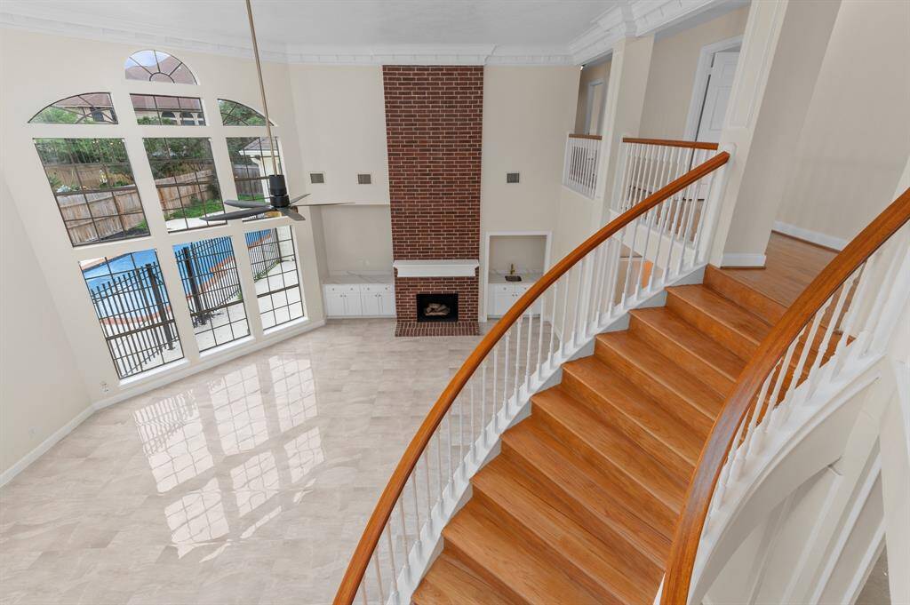 Curved staircase and soaring ceilings upon entrance with custom crown moldings and high-end finishes