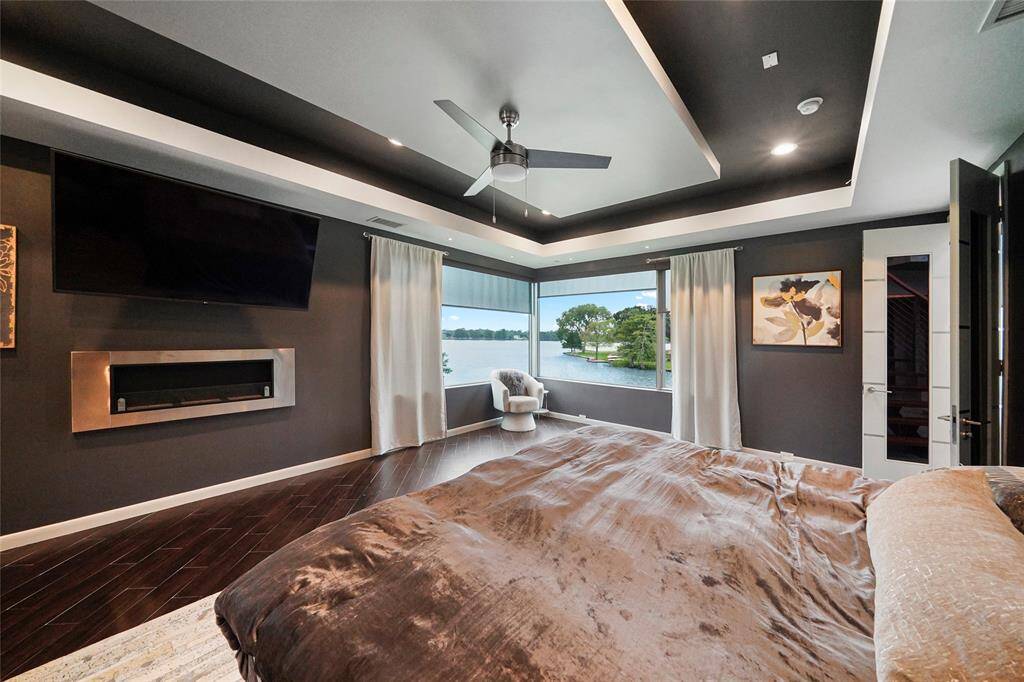 Primary bedroom with fireplace and beautiful water views