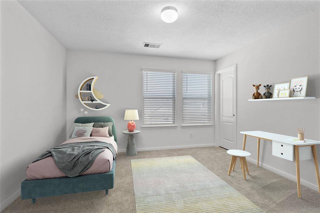 Secondary bedroom features plush carpet, custom paint and a large windows with privacy blinds.