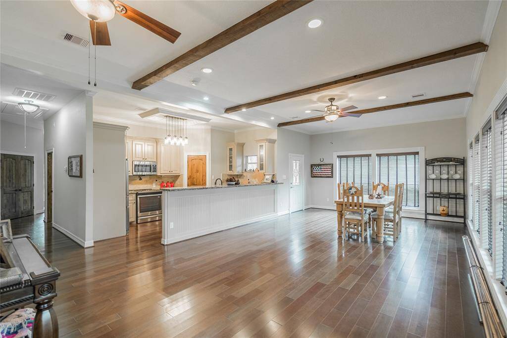 From this view, you can see the kitchen and very large space for the dining room. Large enough to hold your many guests who will be coming out to see "I WILL WALK RANCH. There is enough room here to even put a pool table.