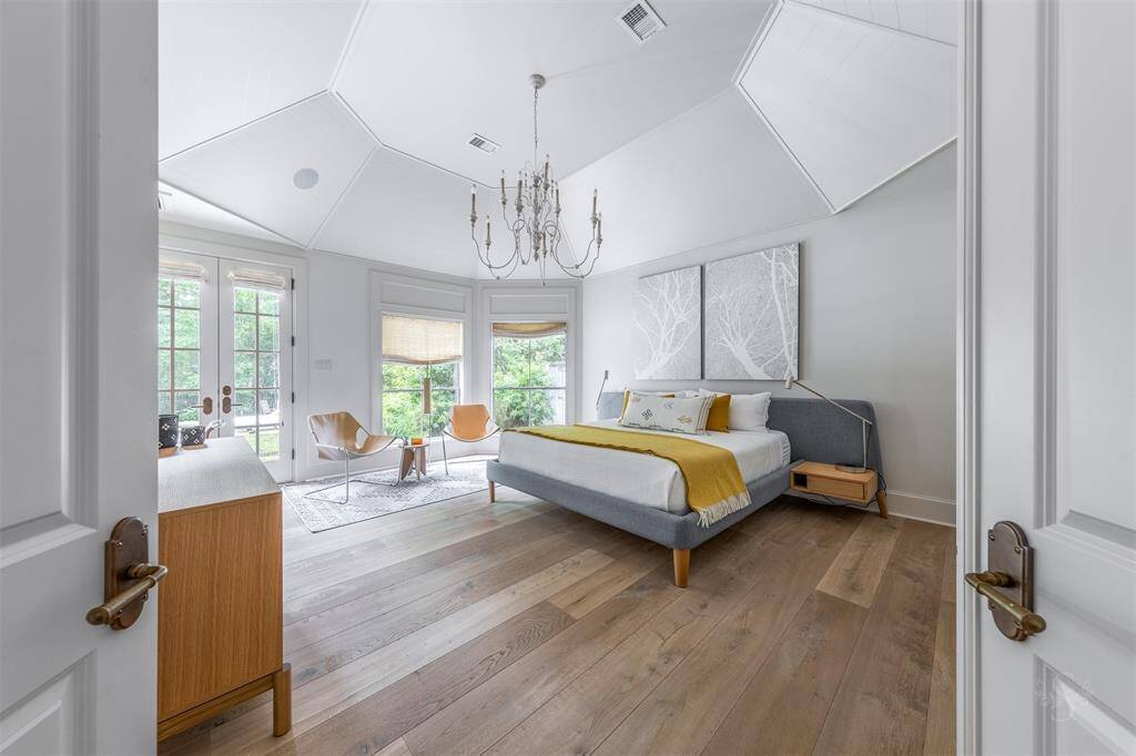 Secluded owner's retreat with sitting area and views to the pool and mature trees.