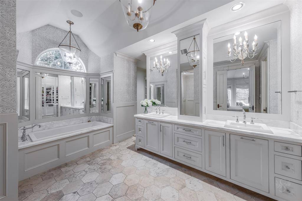 Timeless travertine and calaccatta quartz is the perfect combination to make this primary bedroom as perfect as it is.