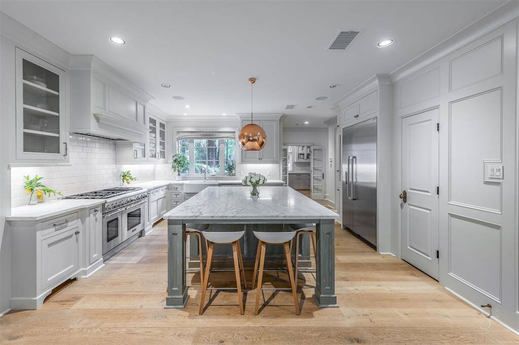 Calaccatta marble countertops, Thermador appliances, custom hand-crafted soft closing cabinets with under-cabinet lighting