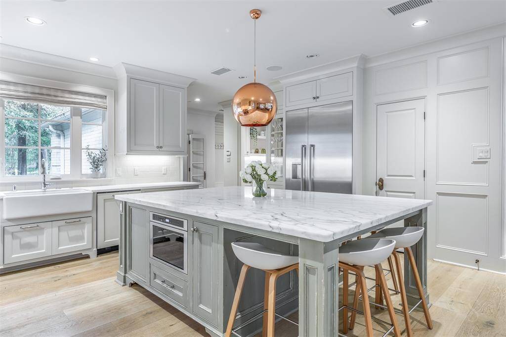 Walk-in pantry next to refrigerator.