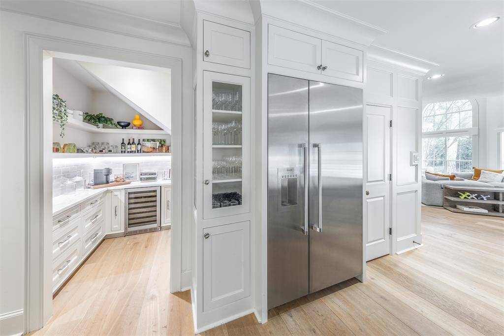 Adorable Walk-in bar complete with wine cooler offers versatility such a coffee bar / serving room