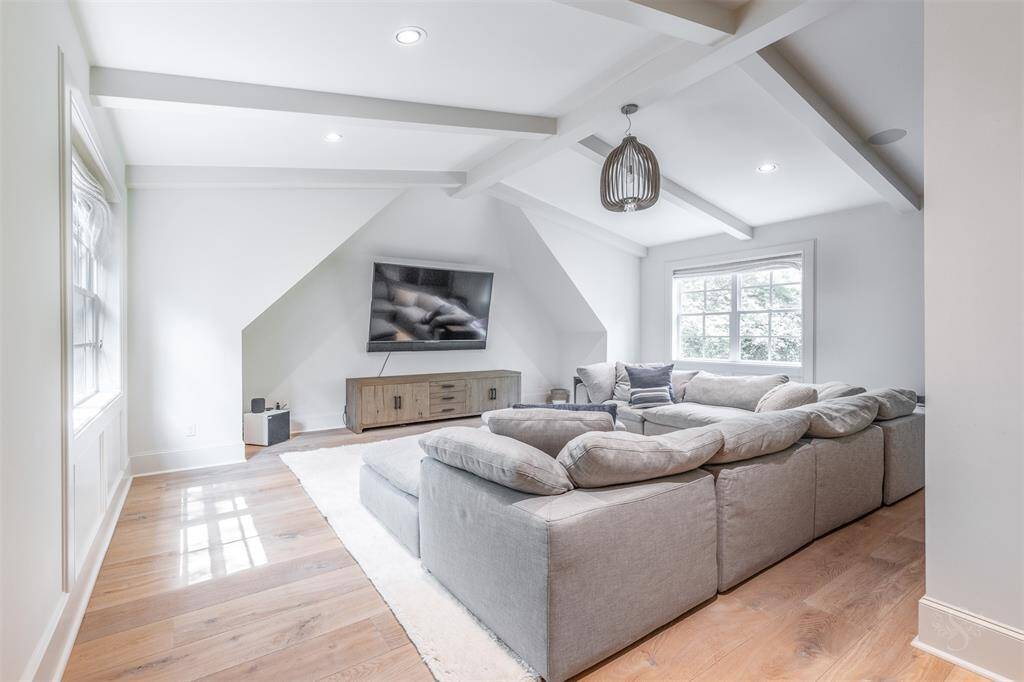 The spacious upstairs game-room measure approximately 22.7' x 17.5' and features surround sound.