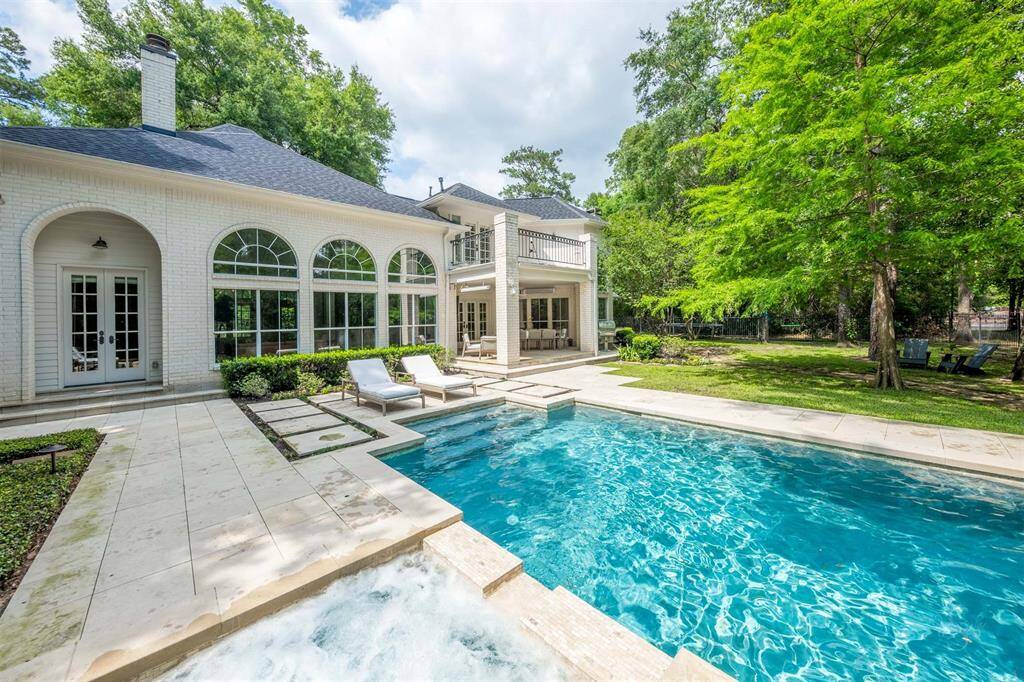 Summer days are easy to enjoy with a pool and mature trees.