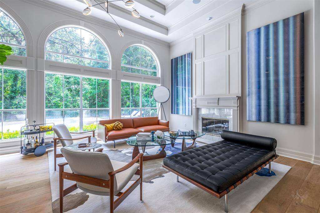 A soaring 14ft floor to ceiling fireplace with marble surround displays the grandeur of the living room.