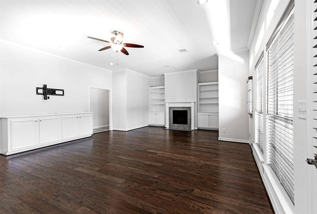 Huge living area with built-ins, gas log fireplace, wood flooring and lots of light from the numerous windows.