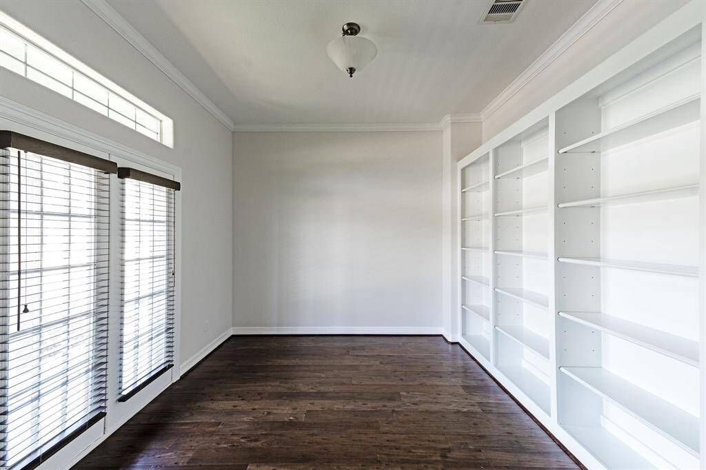 Great study/library/office with built in shelving and a view!