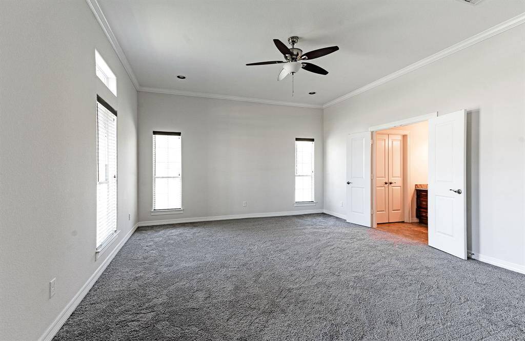 Primary bedroom with separate vanity area that flows to ensuite bathroom