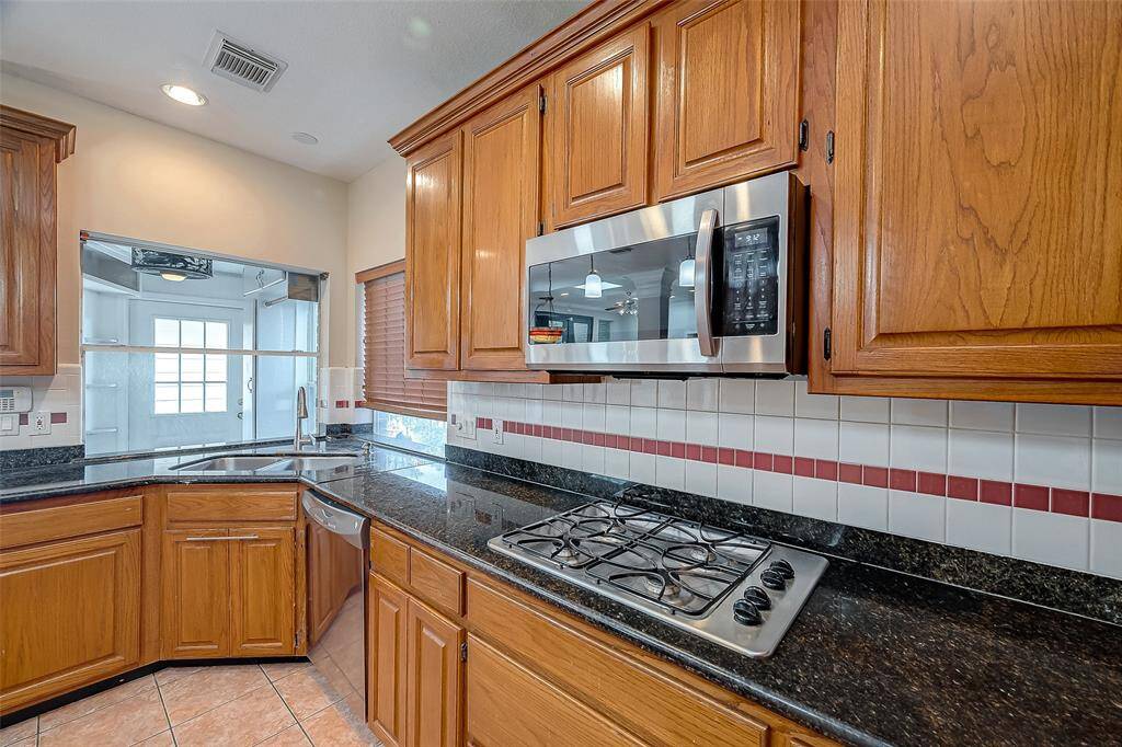 Another view of Kitchen with Microwave and Gas Cooking.
