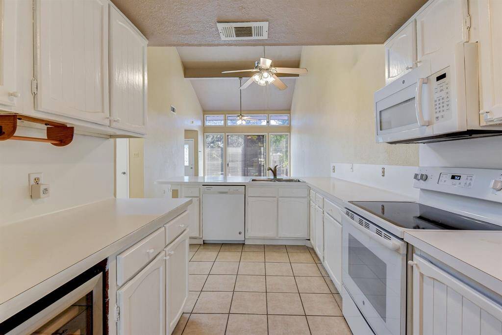 This spacious, open floorplan seamlessly connects the kitchen and living areas.