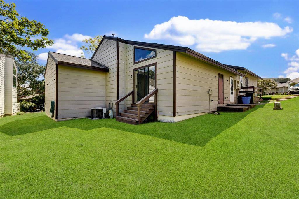 Primary bedroom features sliding doors for direct backyard access.