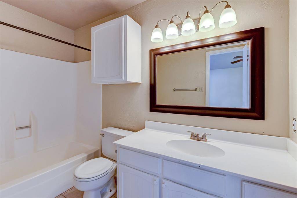 Inviting primary bathroom with ample storage, and a clean, bright design.