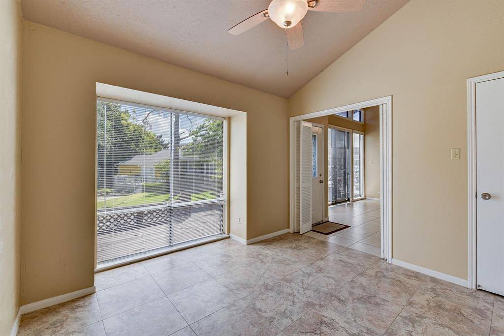 Bright front bedroom featuring large windows with views, perfect for a cozy retreat.