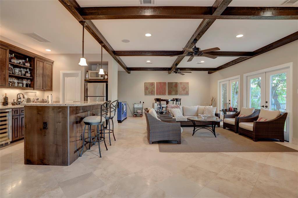 The lakefront entertainment/family room is a dream! Doors open to the lawn and patio, and the climate controls allow for year-round outdoor enjoyment.