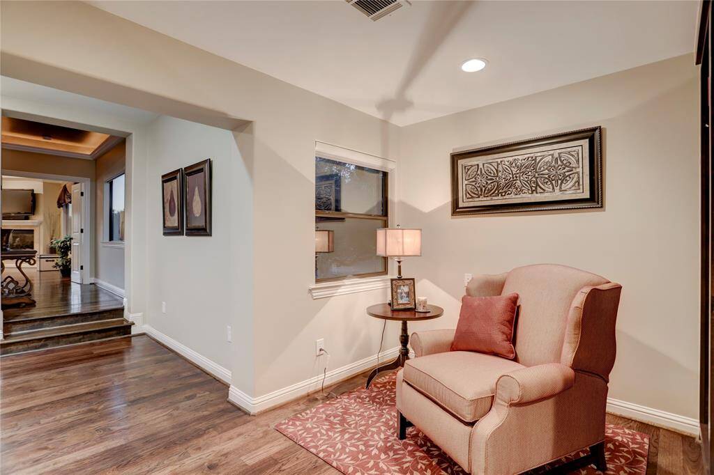 The upstairs niche library segues to the primary suite's coffee bar and private, serene entry