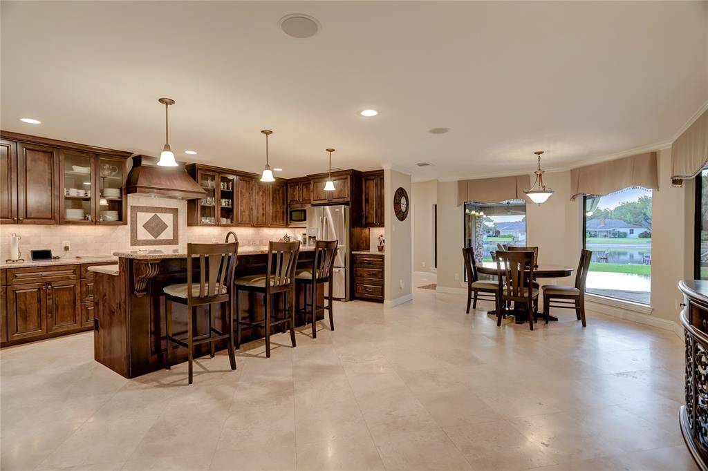 Gorgeous chef's kitchen is filled with natural light. The central location between the recreational/family room and living room creates an ideal flow for entertaining.