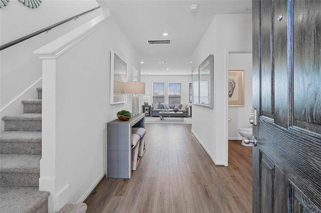 Come inside 8130 Leisure Point where the spacious entryway features gorgeous vinyl plank flooring, custom neutral paint and recessed lighting!