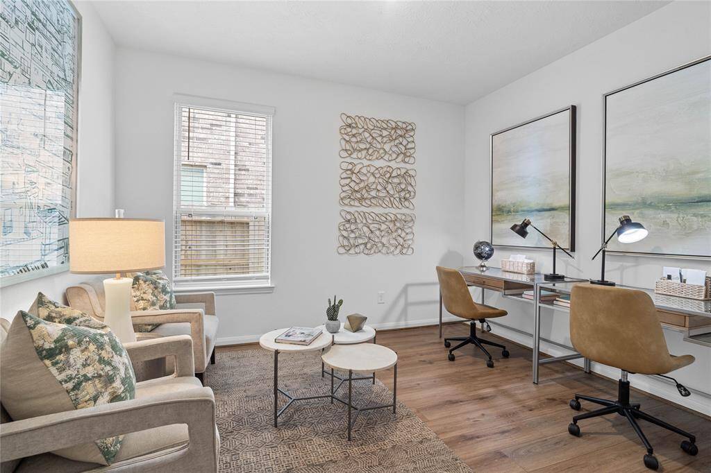 Quietly nestled in front of the home is the handsome Den. Featuring vinyl plank flooring, custom paint, large window with privacy blinds, and lighting.